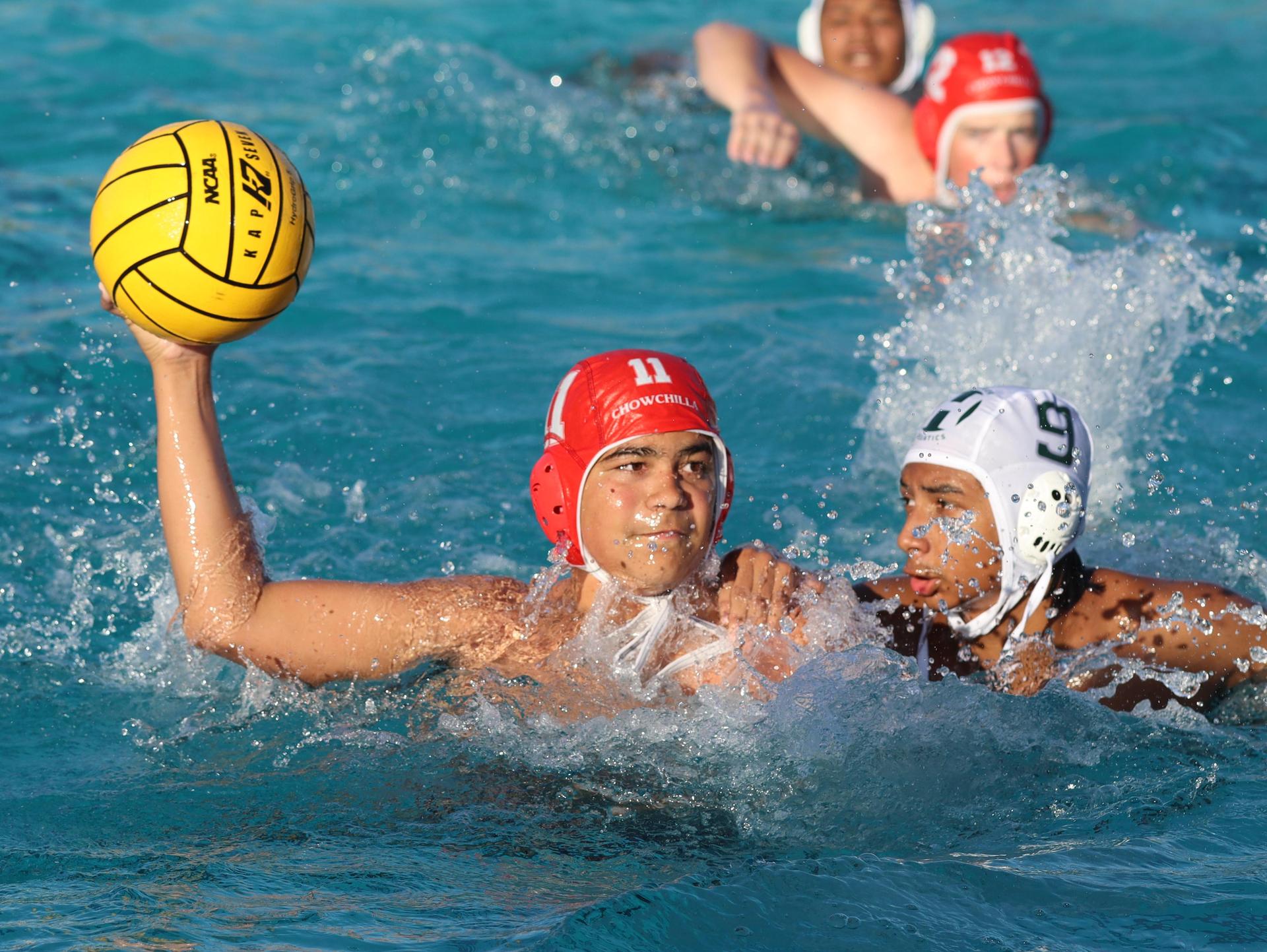 boys water polo players in action against hoover