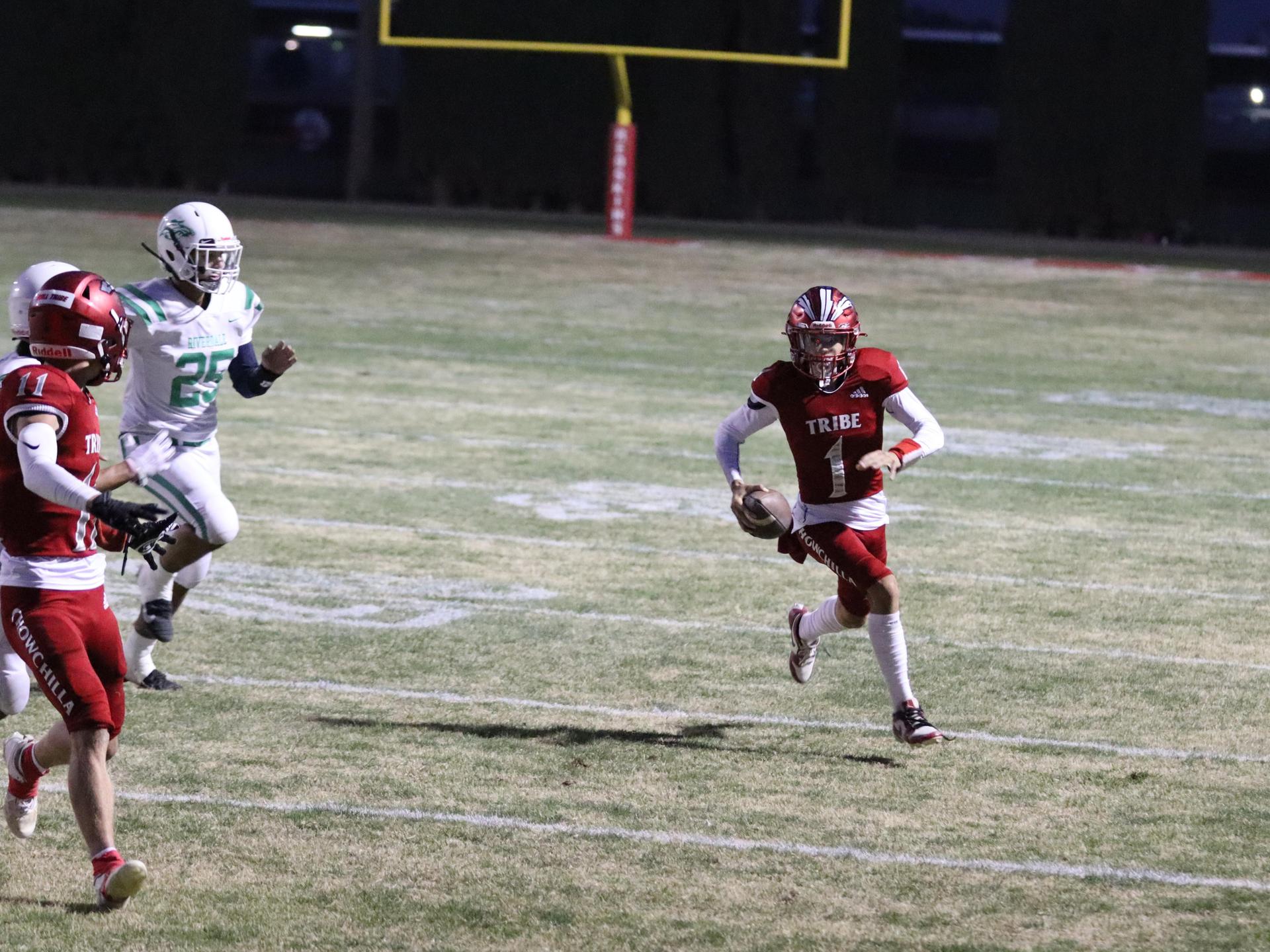 varsity football players in action against Riverdale