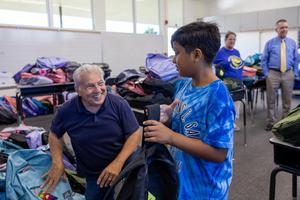 Anaheim Rotary Member Distributing Backpacks