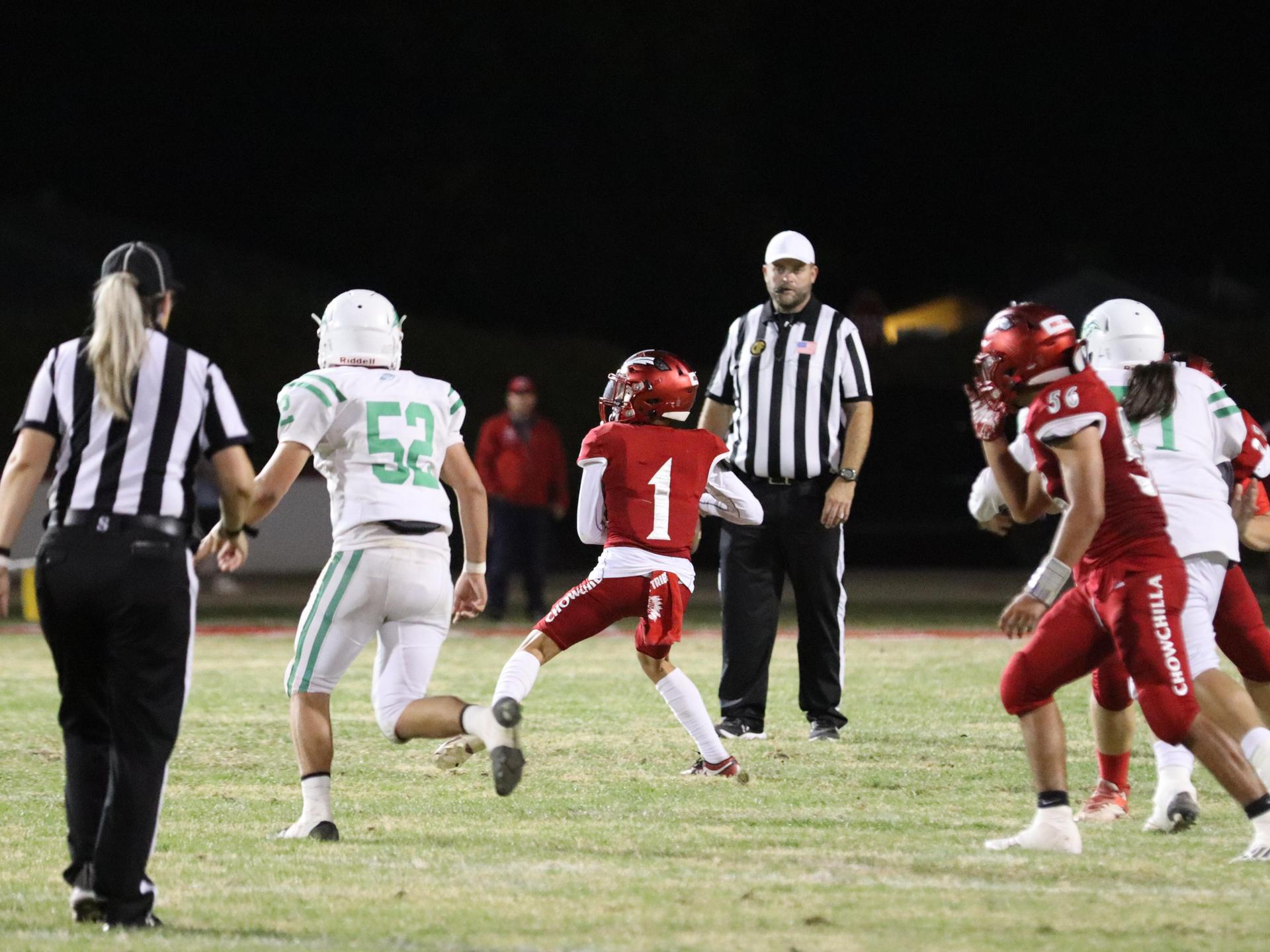 varsity football players in action against Riverdale