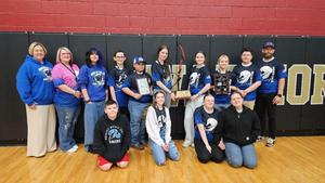 Smiling archery team with trophy