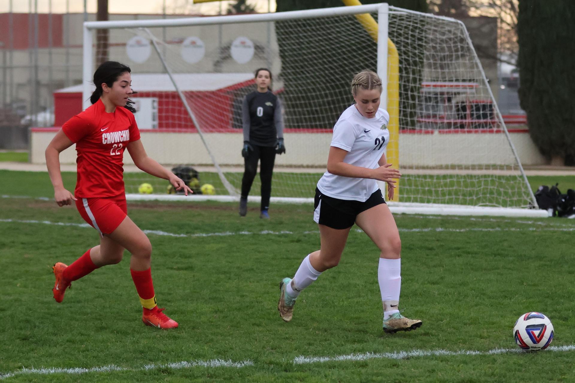 Junior varsity girls playing soccer against liberty