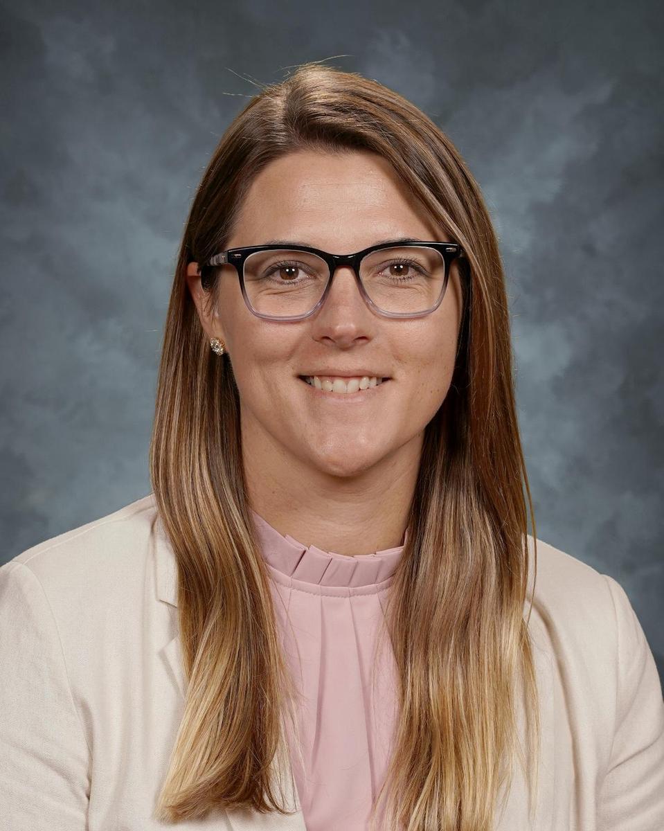woman wearing glasses with long straight hair smiling