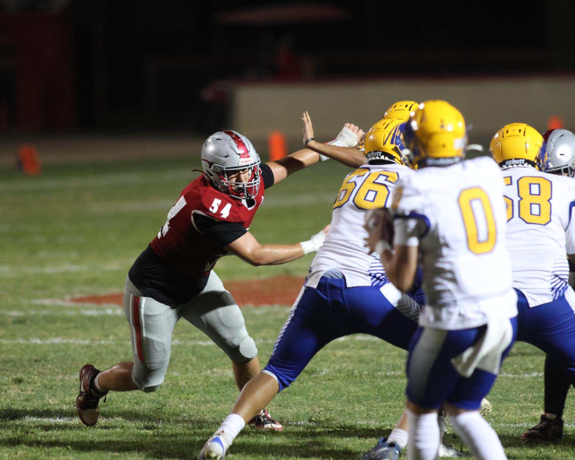 Varsity football players in action against Parlier 156