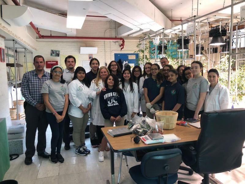 hydroponics labs group proudly showing off their lab