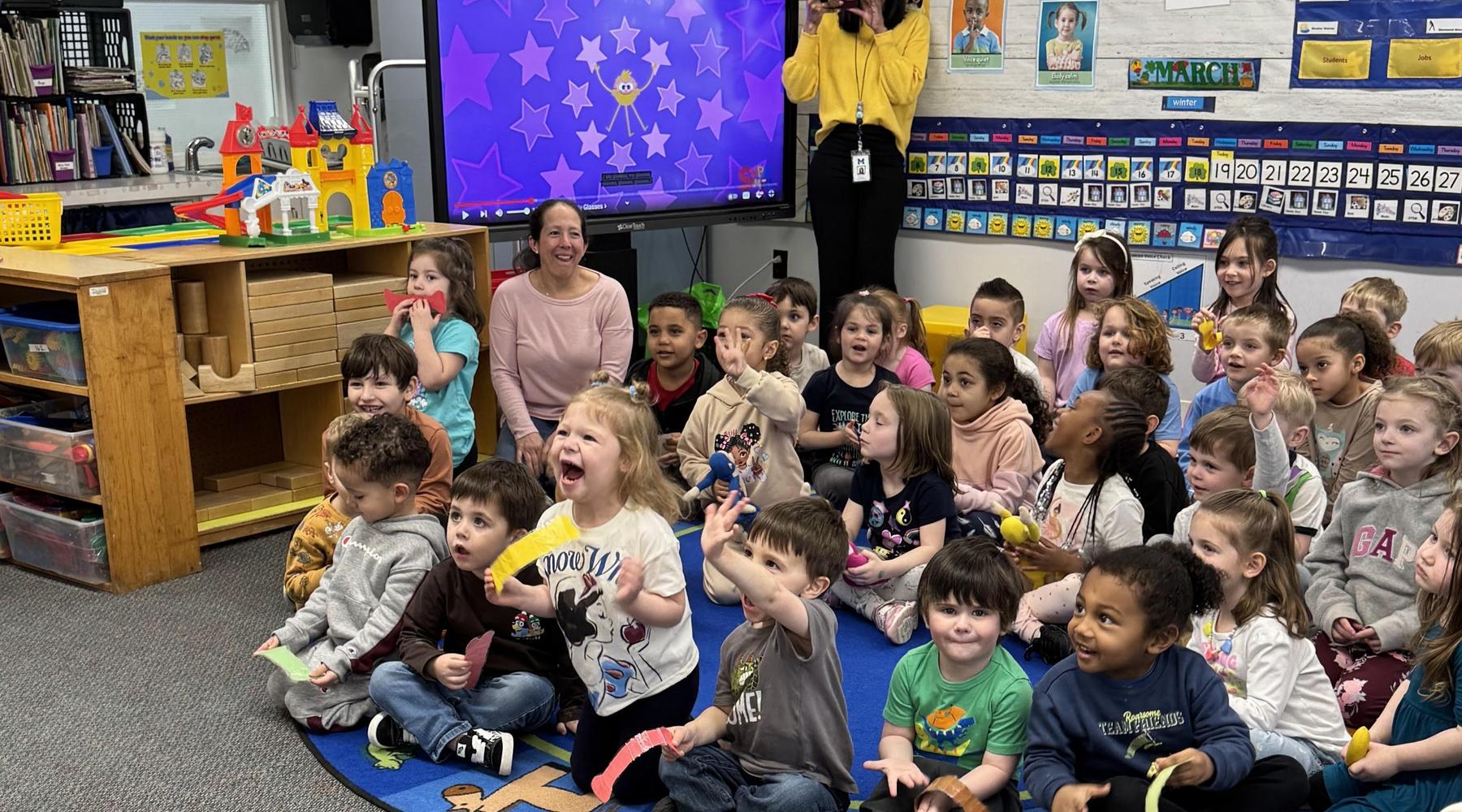 A classroom filled with diverse children joyfully engaged in an activity.
