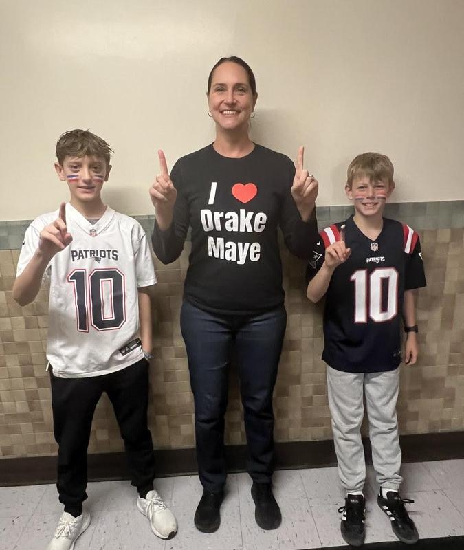 a teacher and 2 students in Patriots jerseys