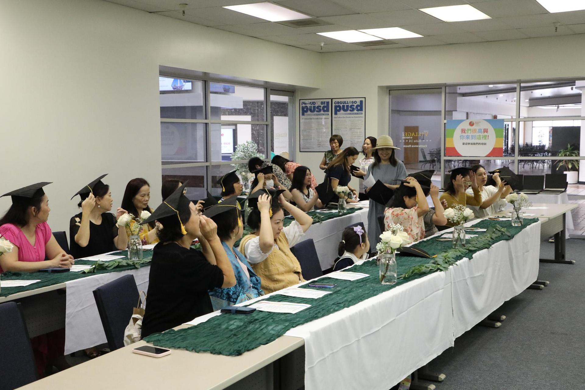 class trying out cap and gown