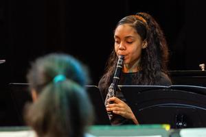 A band member plays their instrument