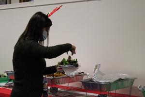 Teacher wearing reindeer headband serving herself food