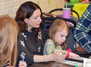 a mother and child playing bingo