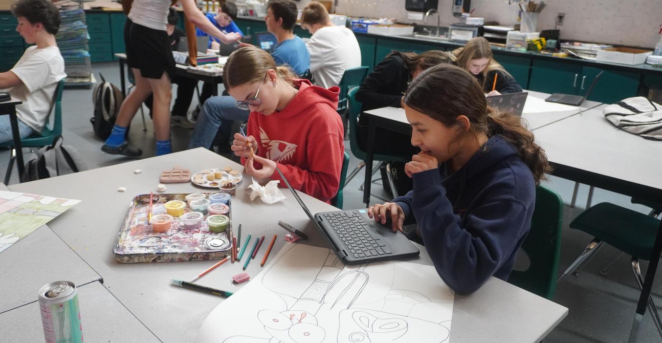 Middle School art students work on a drawing project and a ceramics project.