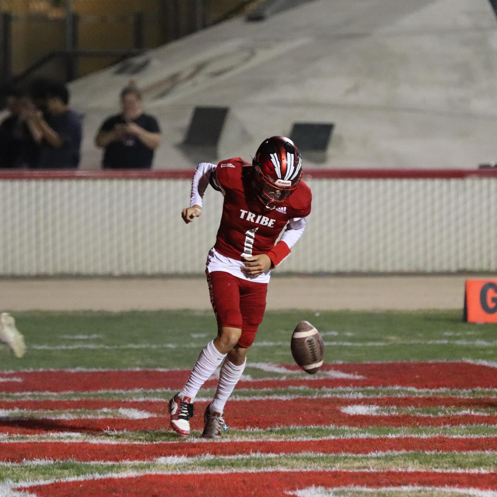 varsity football players in action against Riverdale