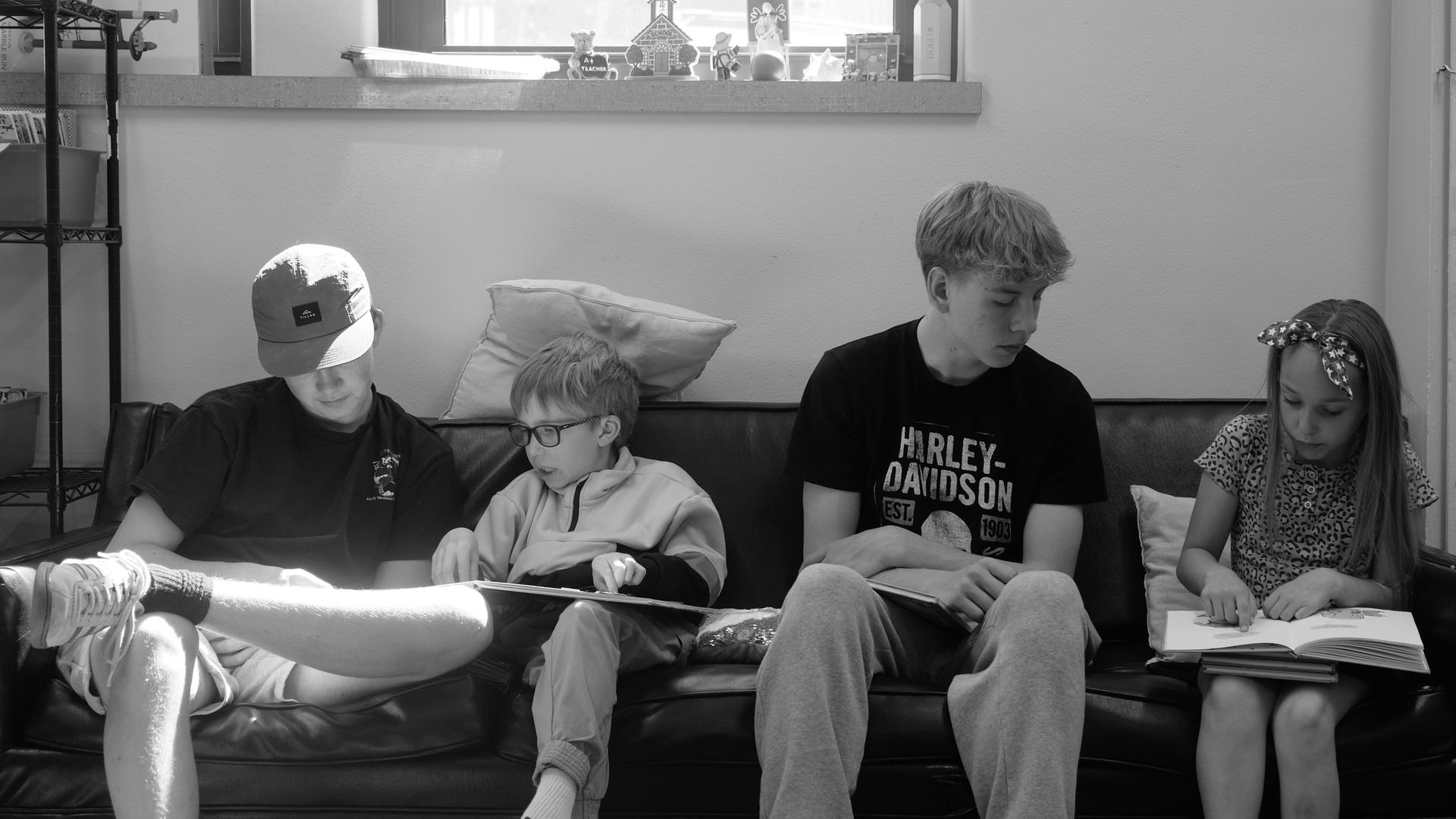 High school students read with elementary students