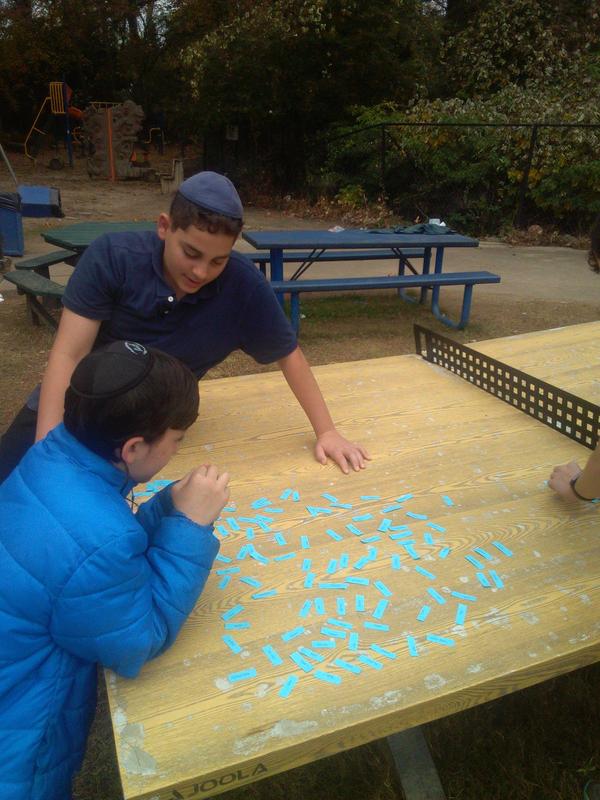 Eighth grade boys choosing the words they want to be tested on.