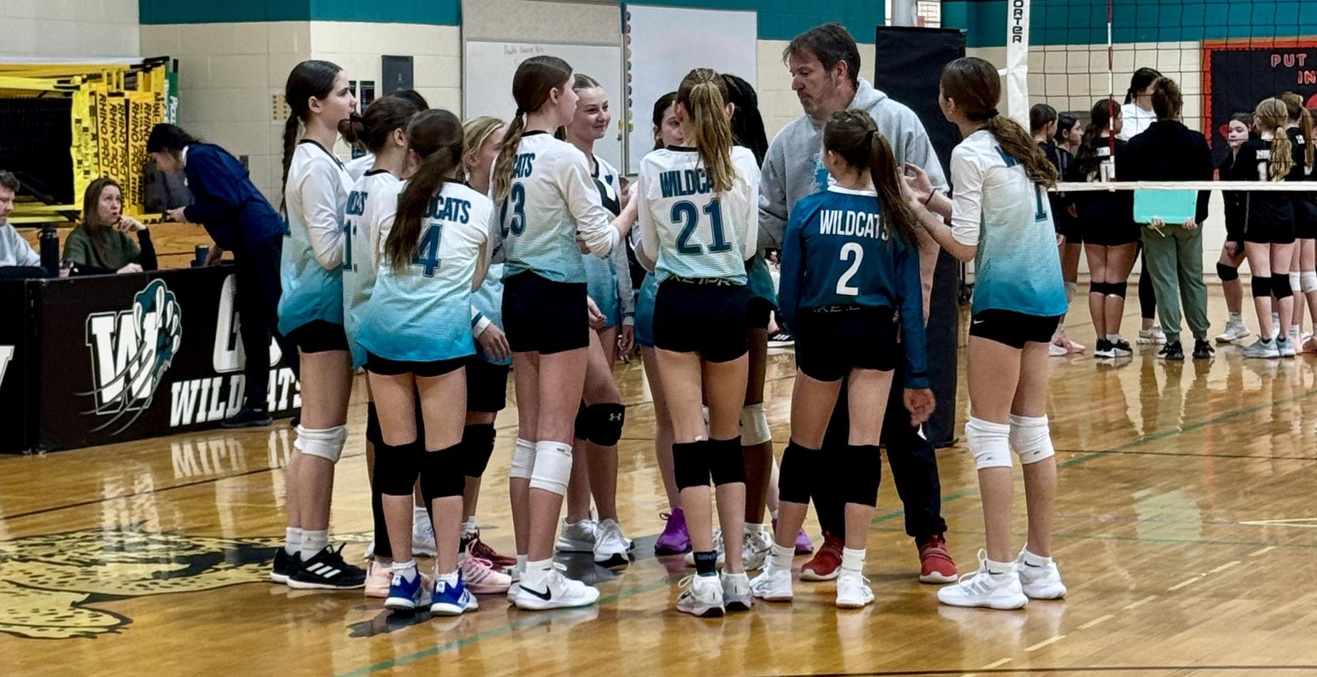 Girls Volleyball Team in huddle
