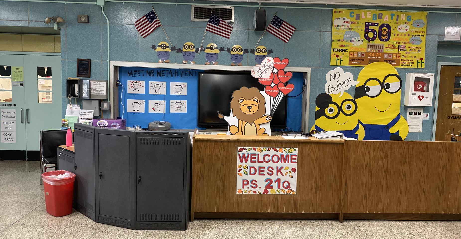 A school reception area with decorations, Minions, and a welcome sign.