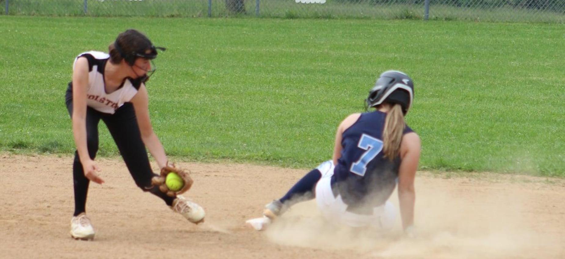 A softball player tags a runner.