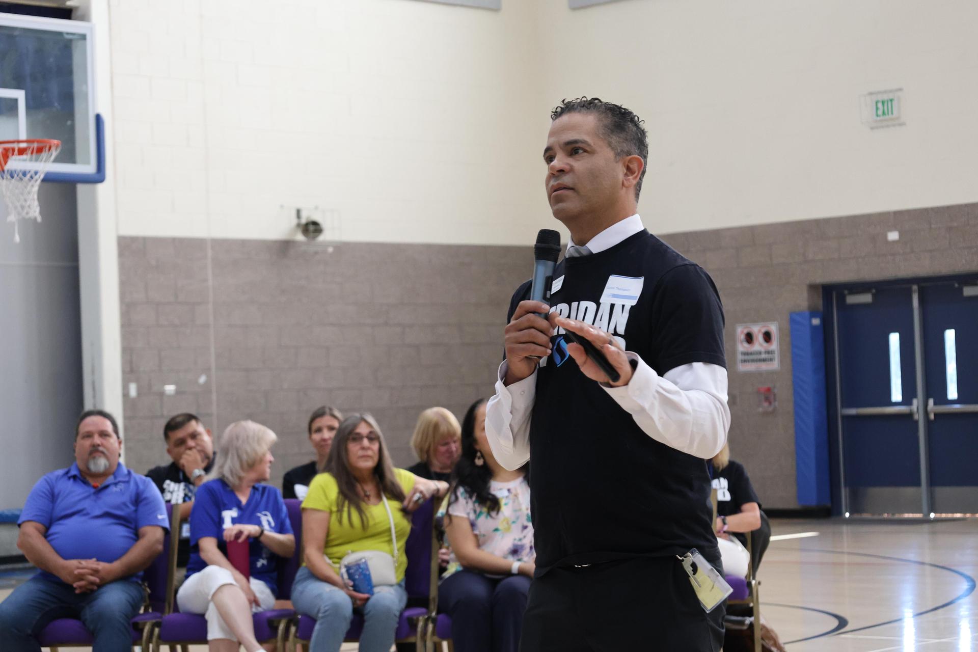 man talking to crowd with mic