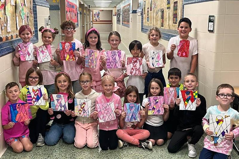 Mrs. Gutwald’s second-grade class at Sunrise Elementary colored ribbons for breast cancer awareness