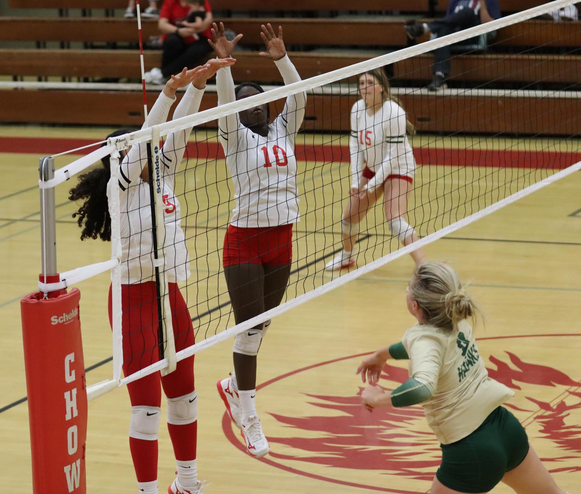 varsity volleyball players in action against liberty