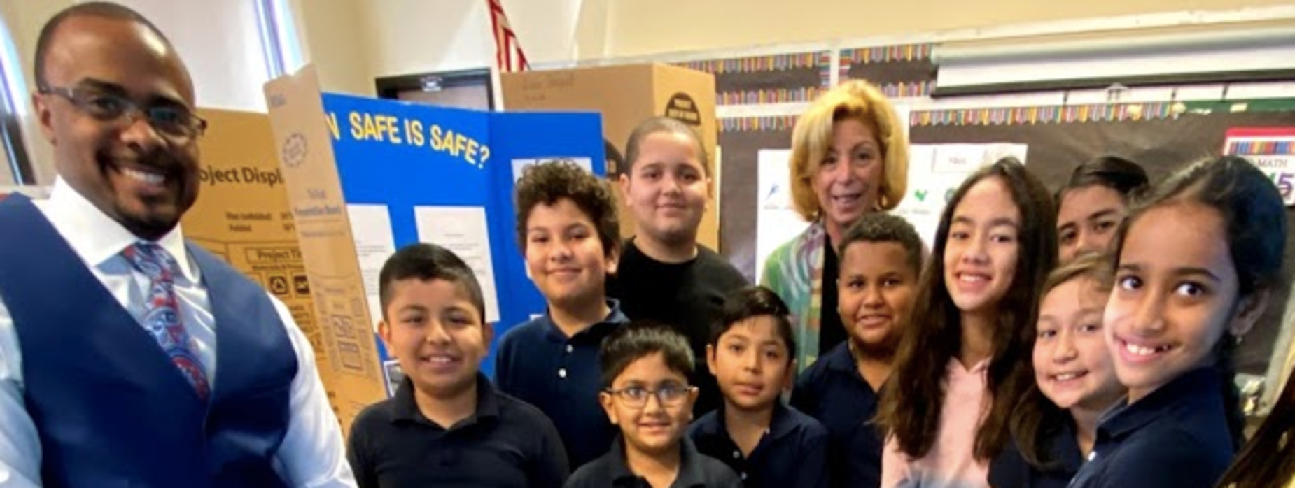 2019 Charles E. Trefurt Elementary School Science Fair Participants stand with projects accompanied by Principal Maris Migliozzi and Vice Principal Darrell Carson