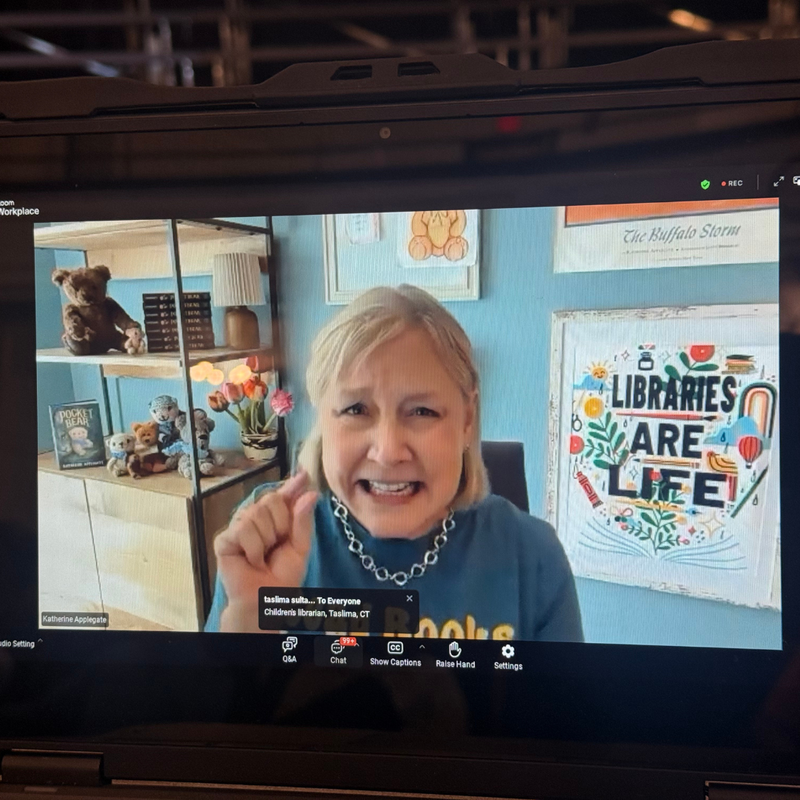 Ms. Applegate on the screen speaking with students