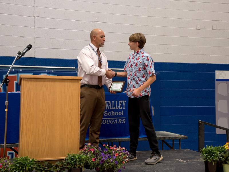 high school principal shaking hands with a student