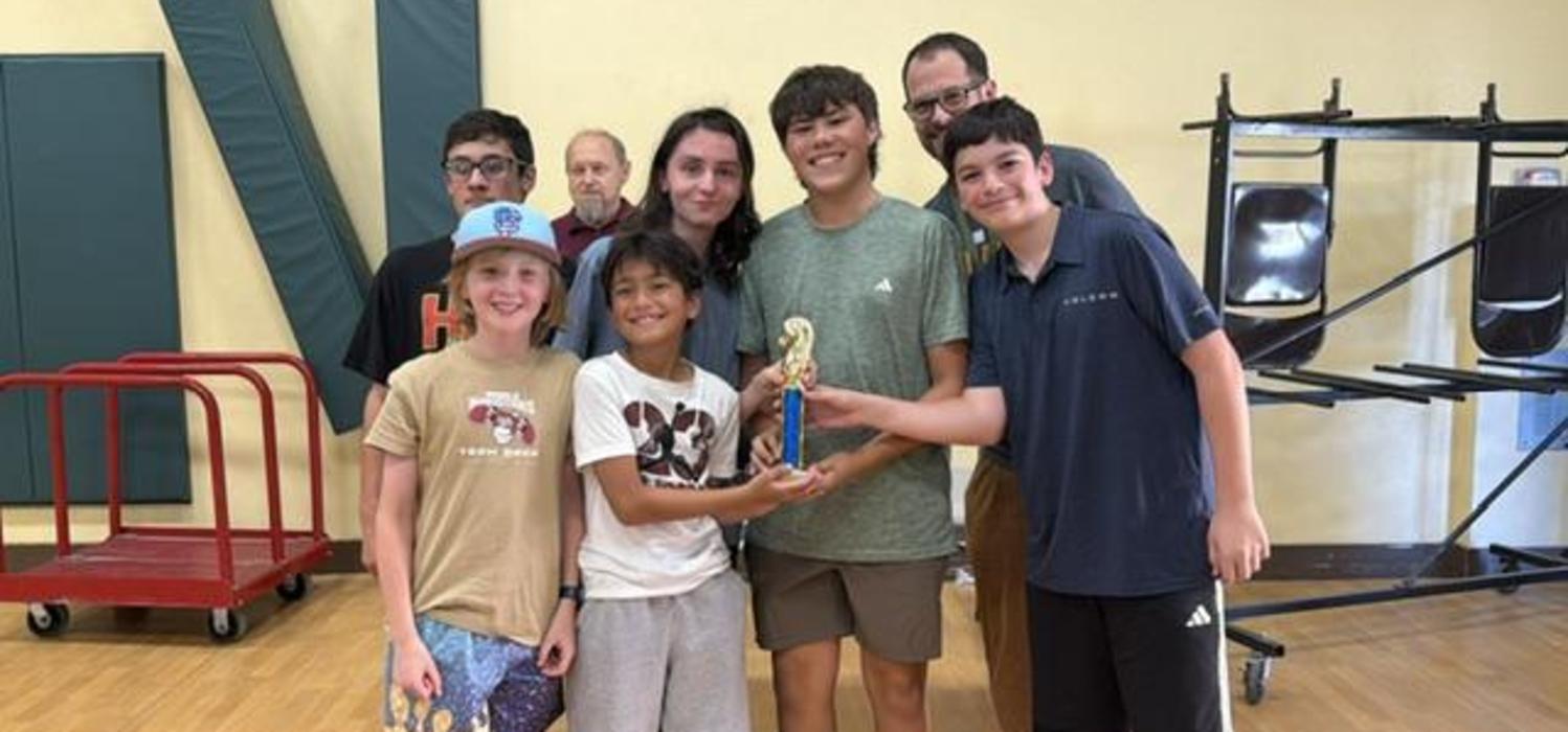 Magnolia's Chess Knights pose with the tournament trophy