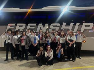 all Memorial High School SkillsUSA students standing in front of the bus with their medals