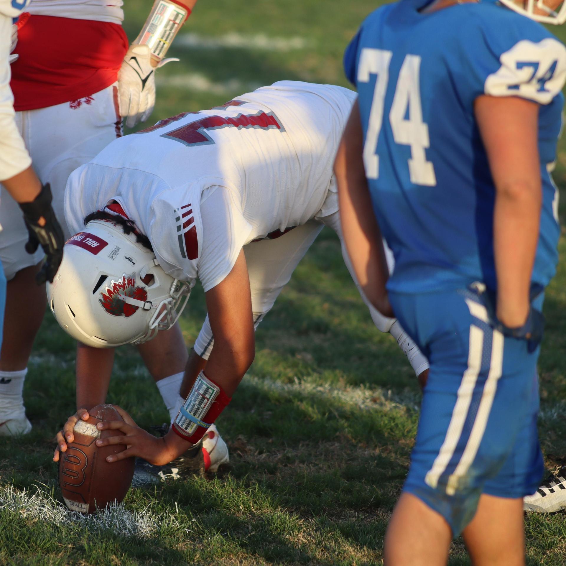 Junior Varsity football players in action against Caruthers