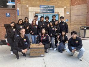 a group of students outside of a build after a victory