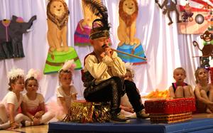 Student dressed as snake charmer performing