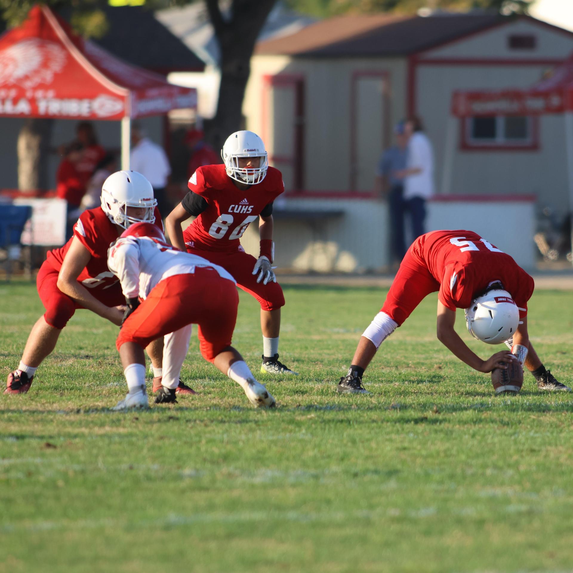 junior varsity football players in action against Fowler