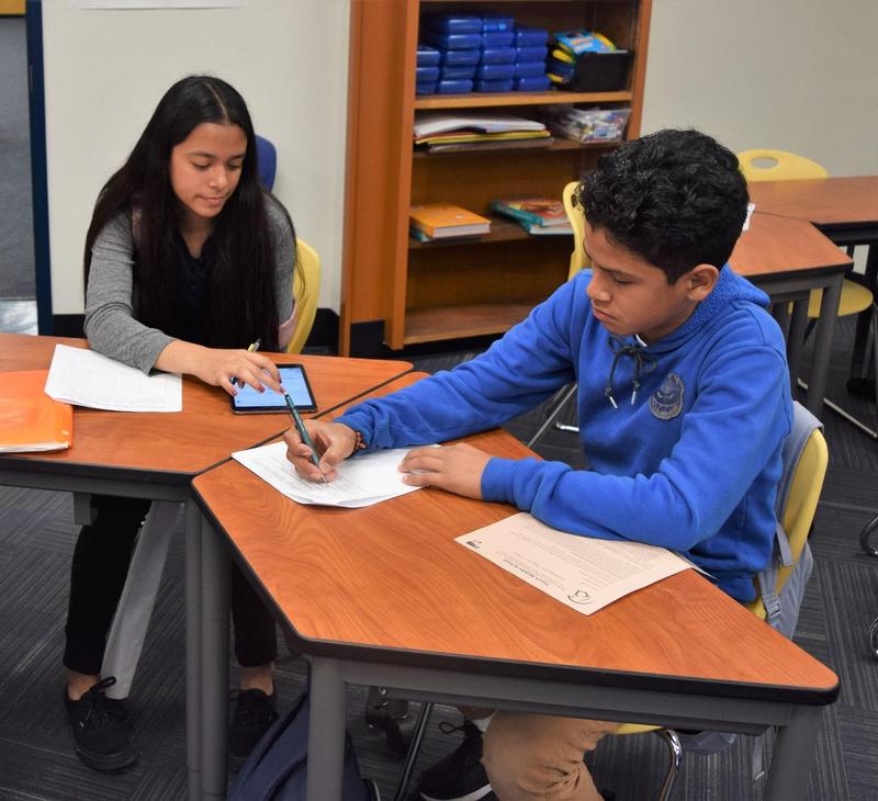 Students signing paper