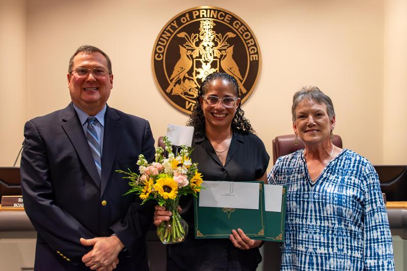 Prince George County Public Schools custodian Mrs. Lisa Dean (middle) is joined by Division Superintendent Dr. Wayne Lyle and Prince George County School Board Chair Mrs. Jill A. Andrews after Mrs. Dean was selected as the division’s 2026 Support Employee of the Year.
