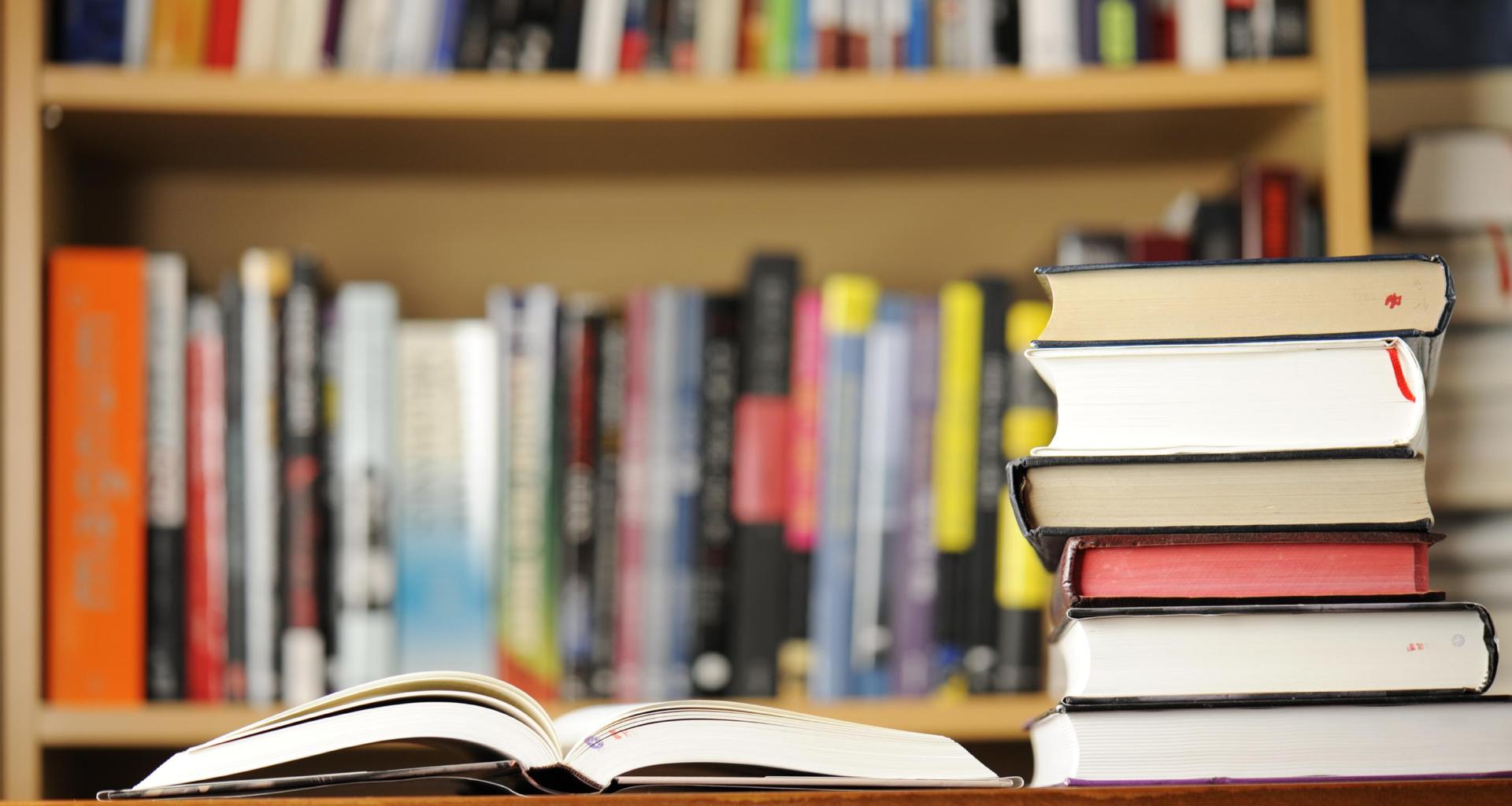 Close up image of stacked books on a desk