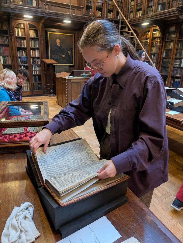 Mrs. Deaton viewing a book.