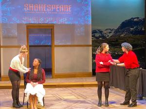 The performers act out a scene