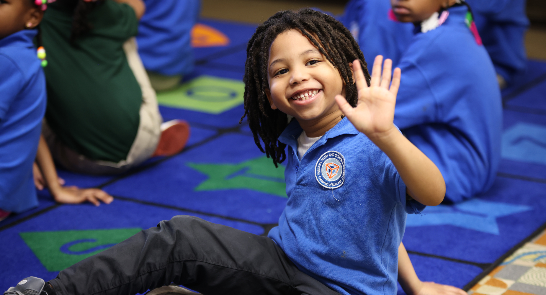 IMSA student waving at camera