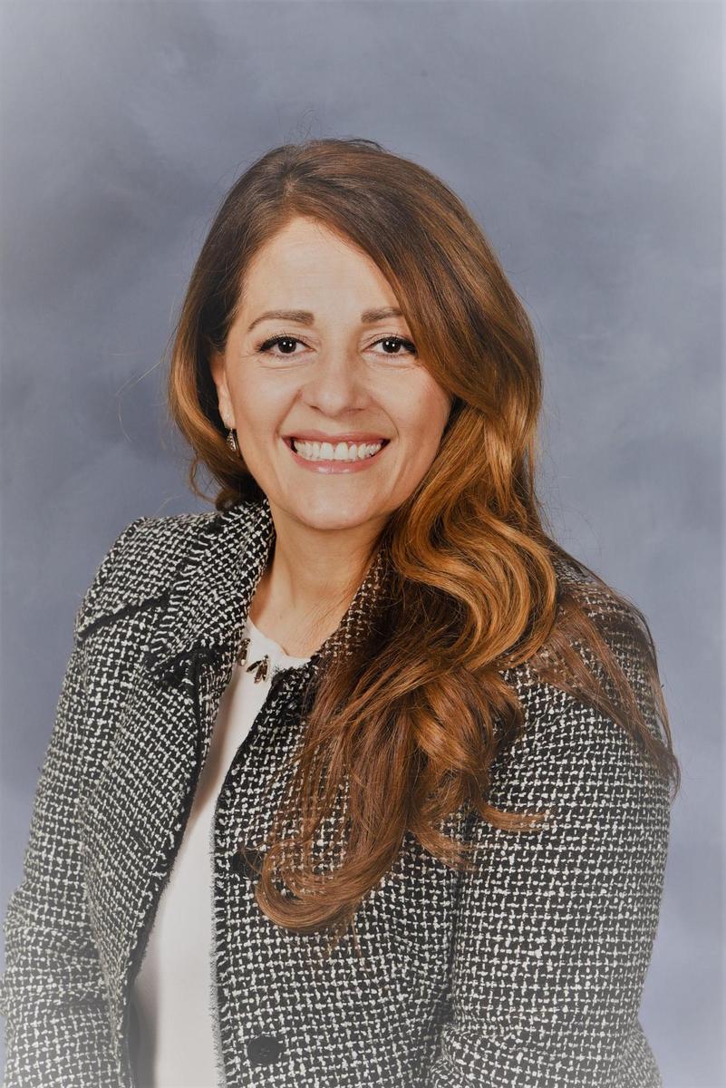 Portrait of Mays Kakish with reddish-brown shoulder length hair