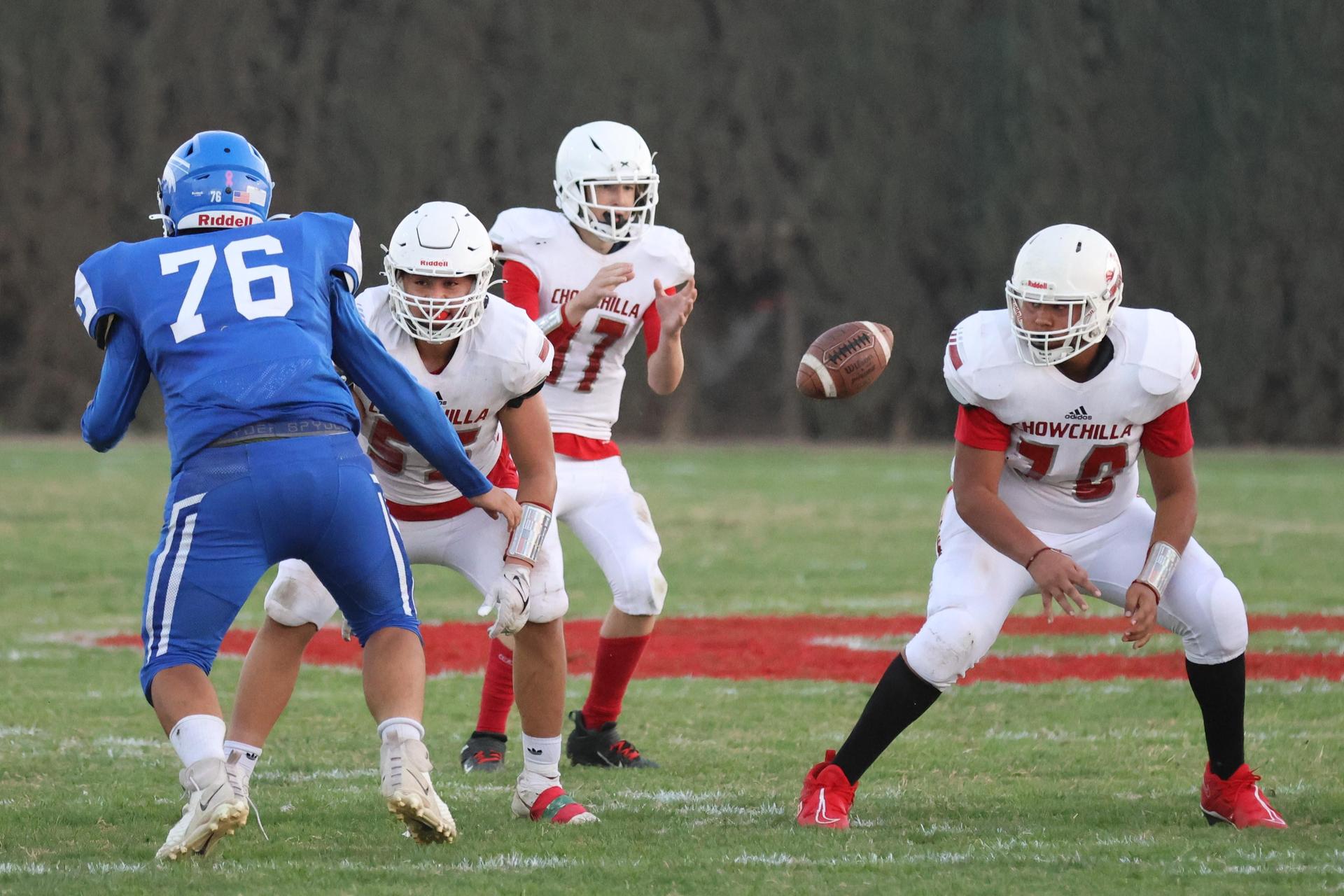 Junior Varsity football players in action against Caruthers