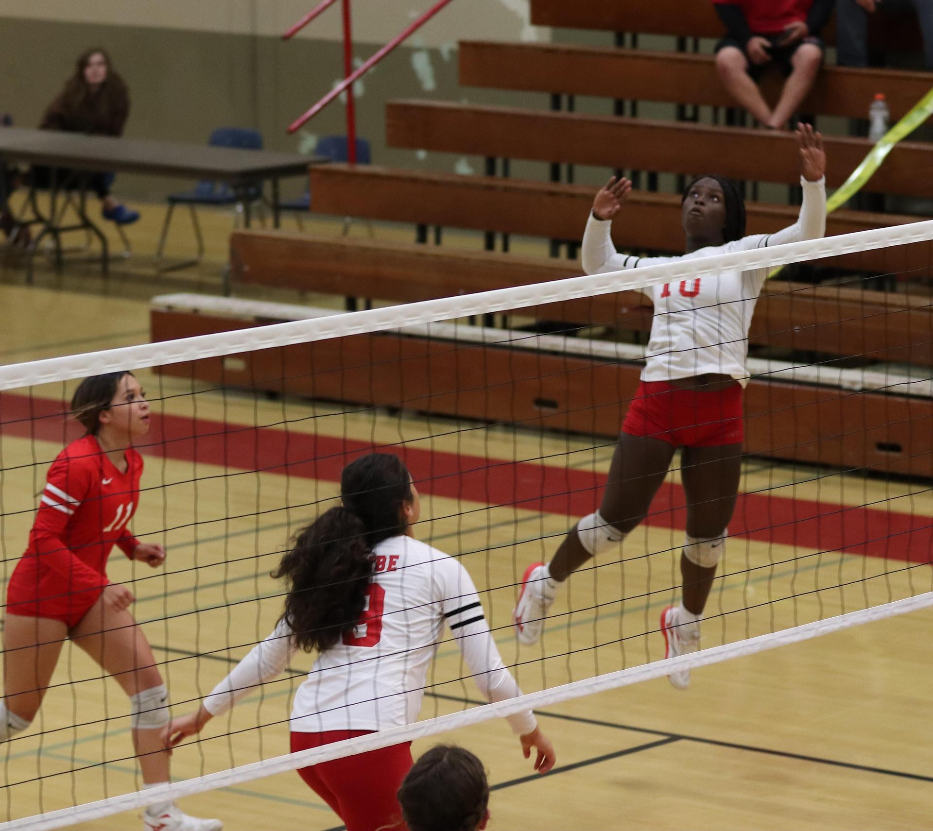 varsity volleyball players in action against Fresno Christian