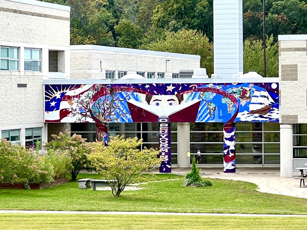 The "Open Your Mind" mural on the outside of the building.