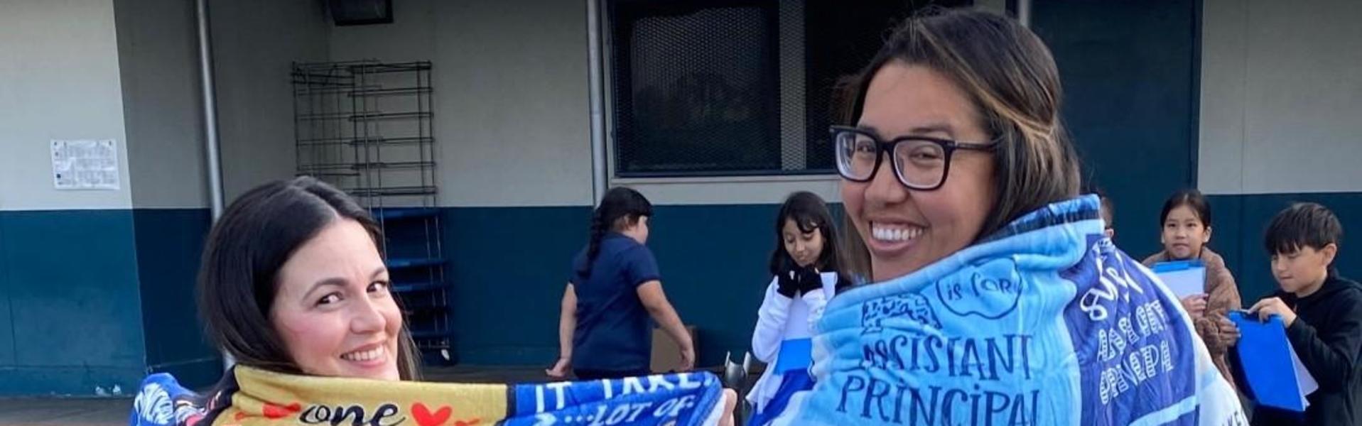 A decorated trash can featuring vibrant messages about school principals.