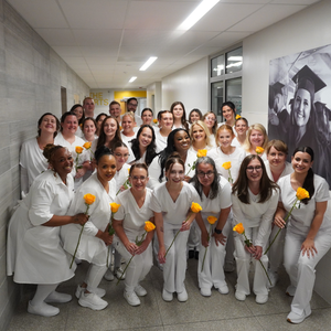 PN students together holding yellow roses
