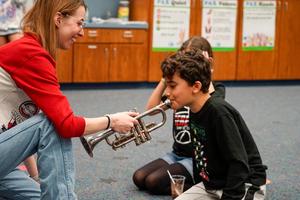 Student learning musical instrument at Legacy Family Steam Night