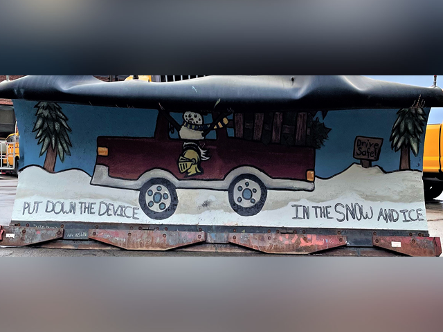 picture of a snow plow with a painting on it