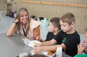 Lee Elementary Principal Sara Jewett sits with students at lunch time.