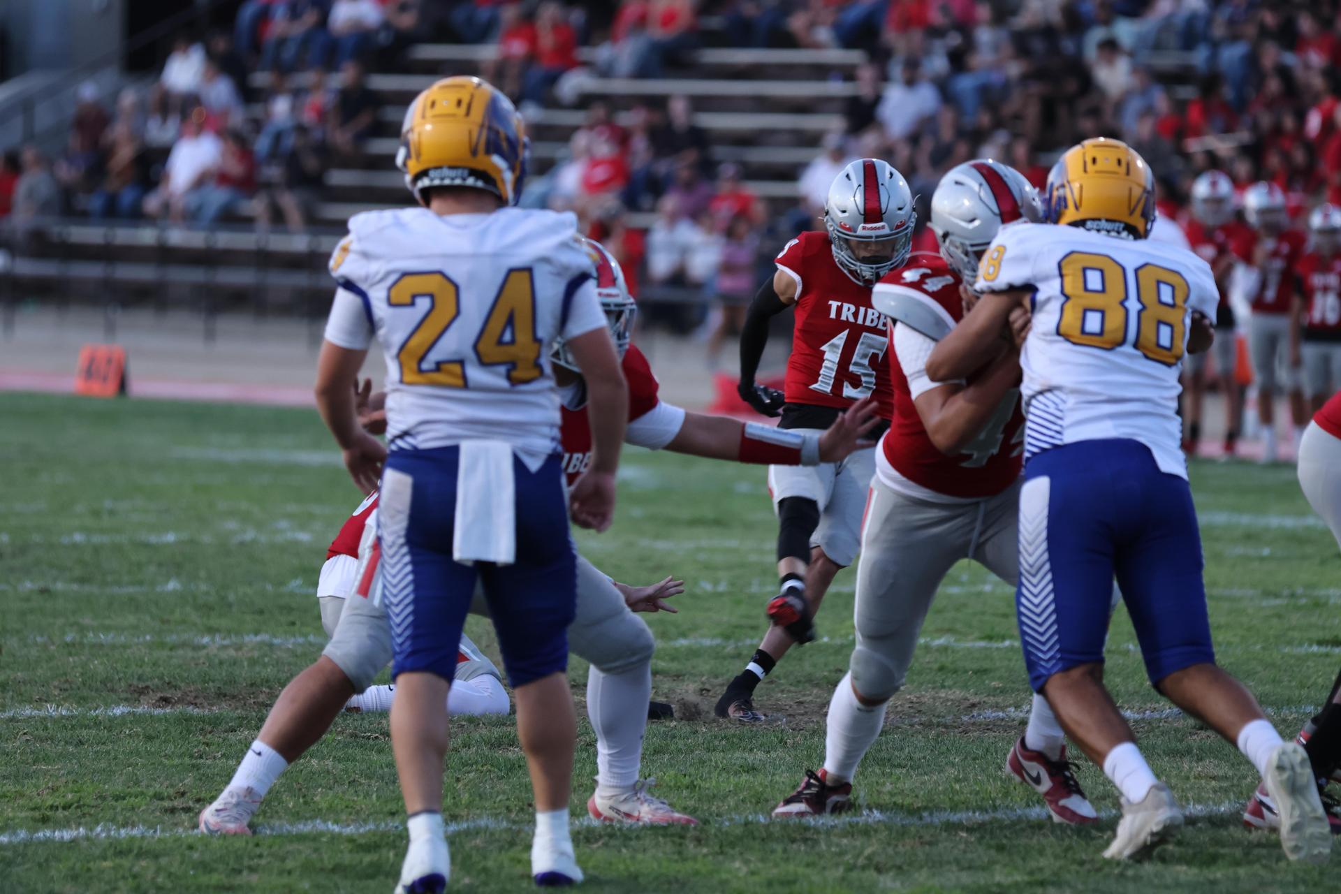 Varsity football players in action against Parlier 4
